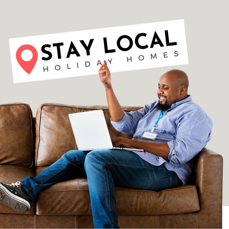 Happy client holding a Stay local Logo Sign